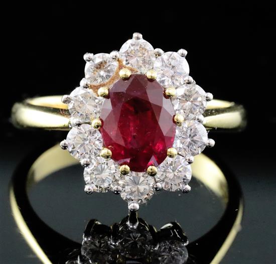 An 18ct yellow gold and platinum, ruby and diamond oval cluster ring, size O/P.